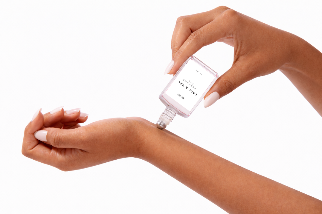 LALI & TAL No. 250 perfume oil being applied to the wrist using a roll-on bottle.