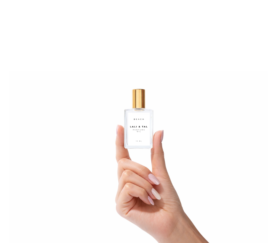 Hand holding a bottle of LALI & TAL BEACH perfume oil to show size and scale.