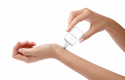 LALI & TAL BEACH perfume oil being applied to the wrist using a roll-on bottle.