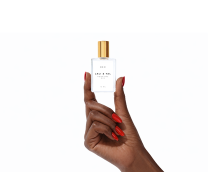Hand holding a bottle of LALI & TAL BED perfume oil to show size and scale.