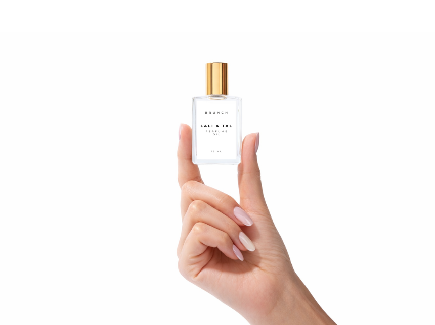 Hand holding a bottle of LALI & TAL BRUNCH perfume oil to show size and scale.