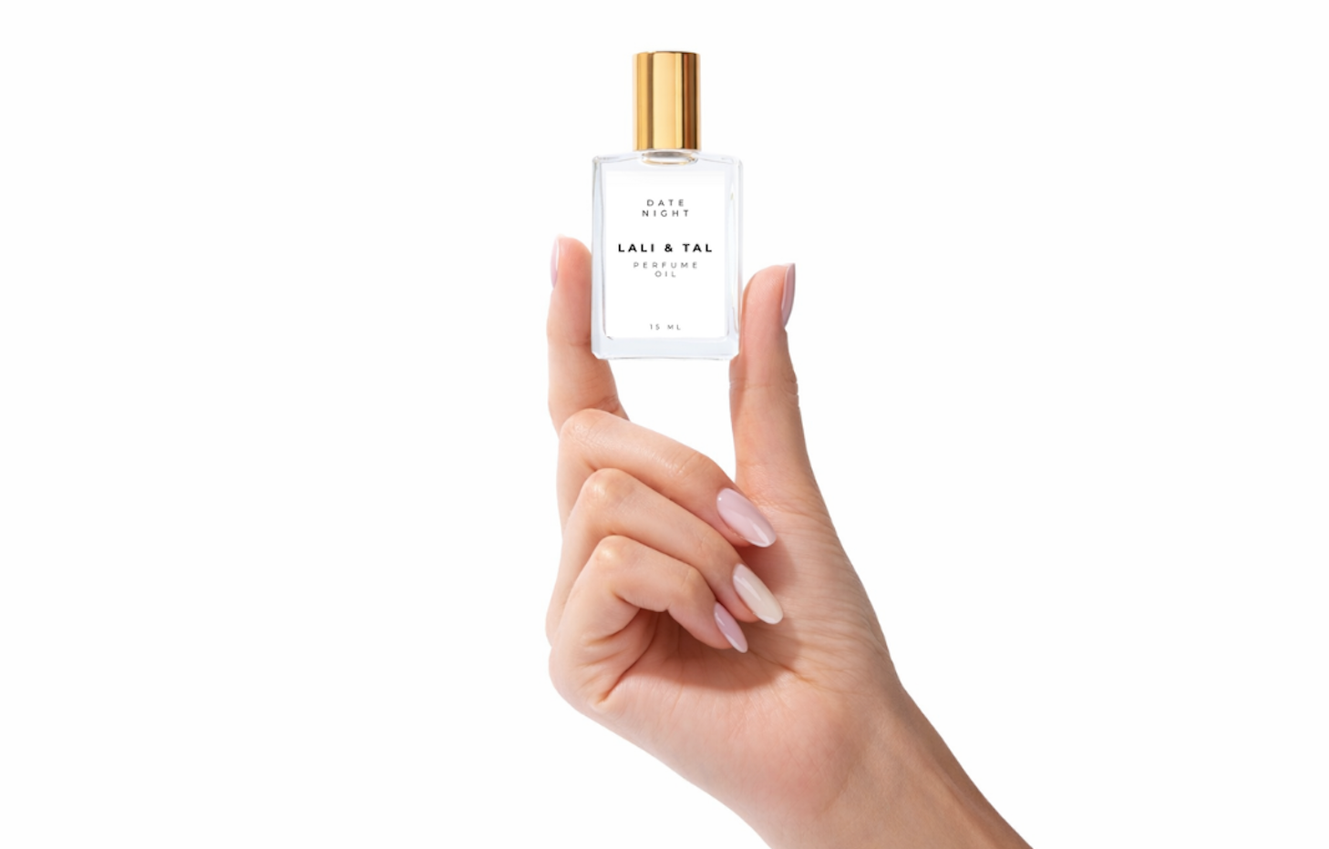 Hand holding a bottle of LALI & TAL DATE NIGHT perfume oil to show size and scale.