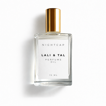 A 15 ml bottle of Nightcap Lali & Tal Perfume Oil. The clear glass bottle features a white label with black text and is topped with a shiny gold cylindrical cap, set against a clean white background with a soft shadow.