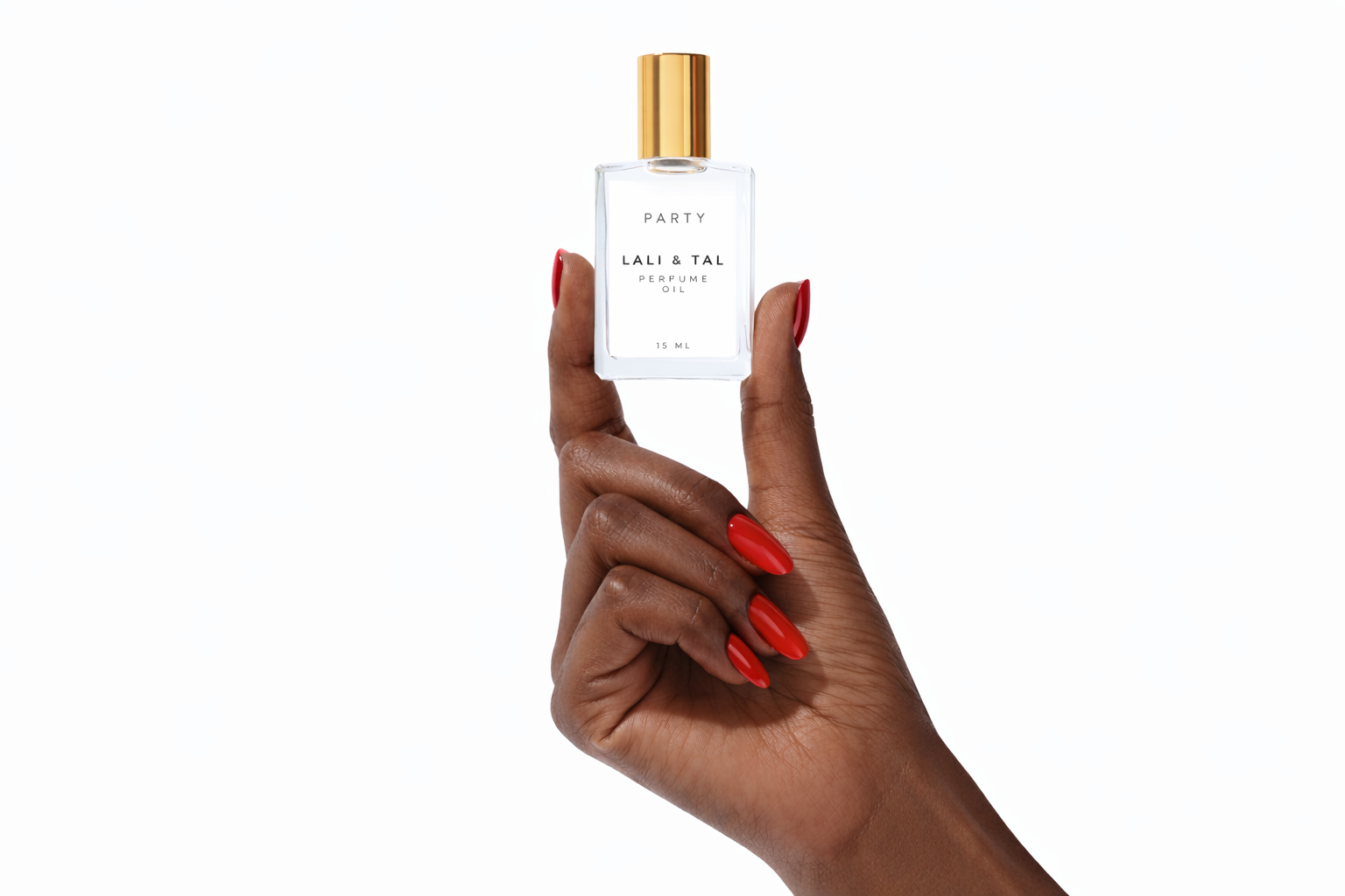 Hand holding a bottle of LALI & TAL PARTY perfume oil to show size and scale.