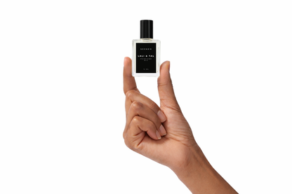 Hand holding a bottle of LALI & TAL SEEKER perfume oil to show size and scale.
