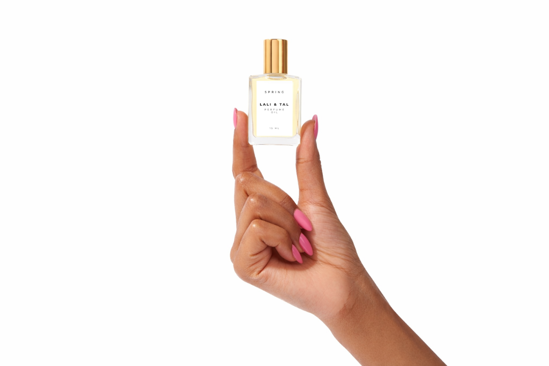 Hand holding a bottle of LALI & TAL SPRING perfume oil to show size and scale.